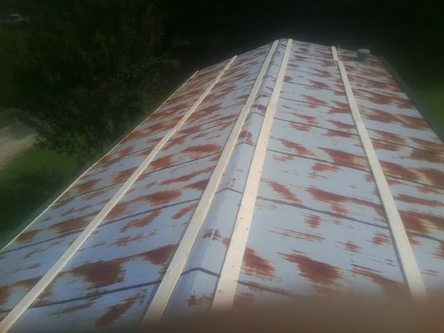 Rusted metal roof panels with new wood purlins before replacement — Storm Damage Roof Repair in Desoto by Roofing Brothers