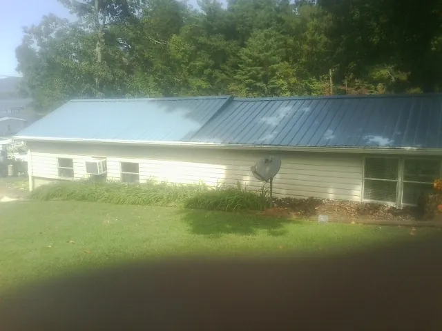 Blue metal roof running the length of a single story home in Desoto
